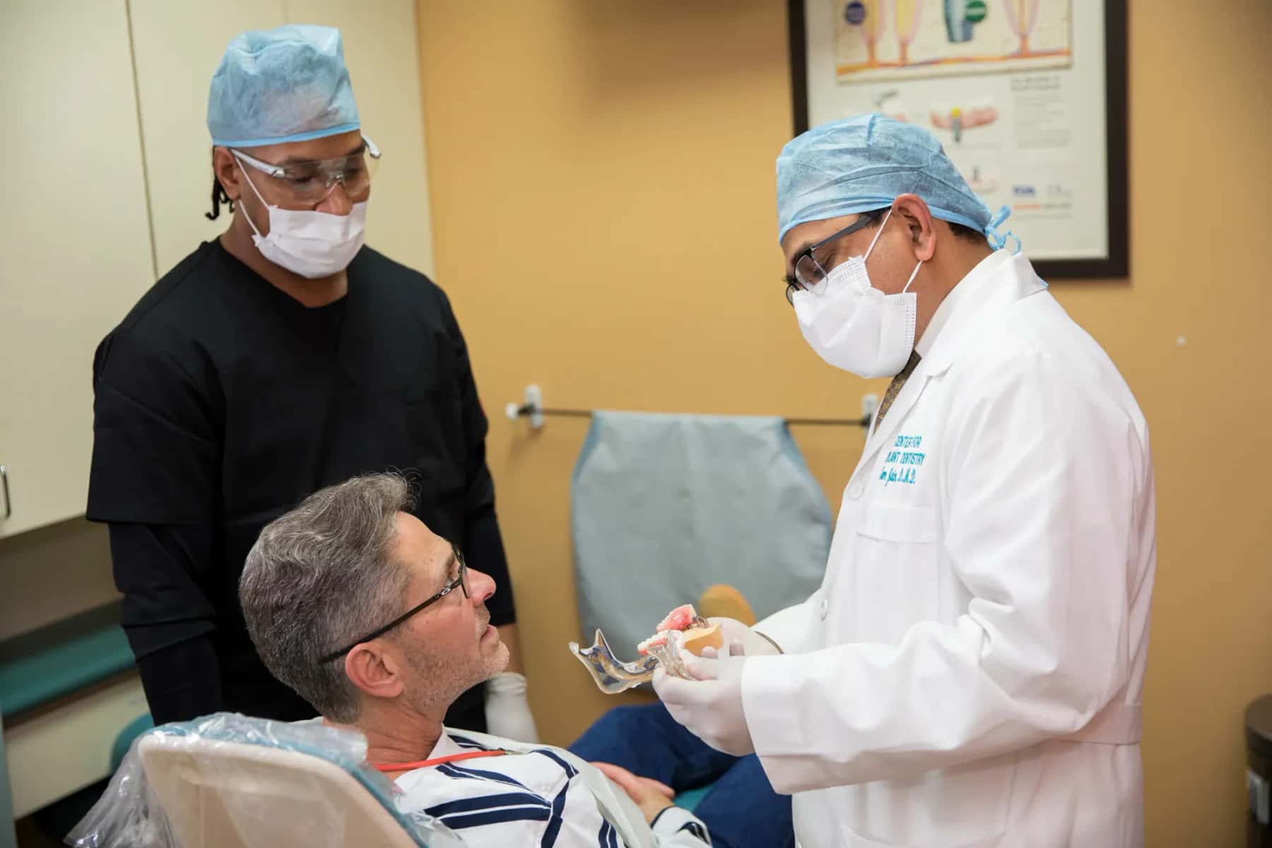 Implant specialists reviewing treatment plan for complex full-mouth dental restoration